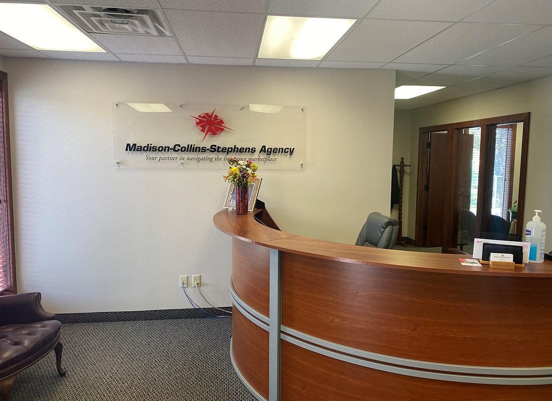 Newark, OH Insurance - Inside Madison-Collins-Stephens Agency Office with Front Desk and Acrylic Sign with Agency Logo